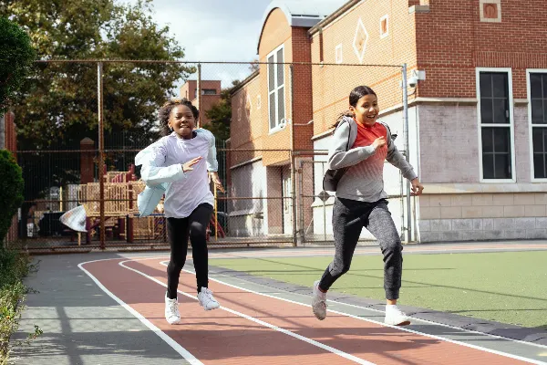 Two grils racing on a running track