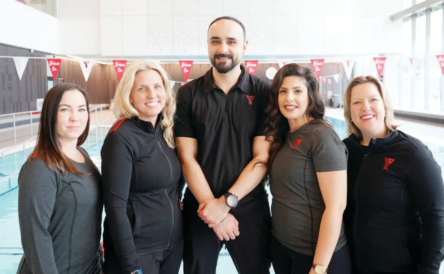 YMCA staff standing at the pool