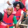 children wearing life jackets